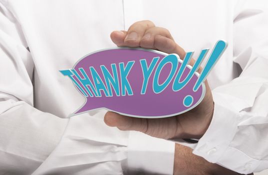 Image of a man hand holding speech balloon with the text thank you, white shirt. Concept for acknowledgement and thanks.