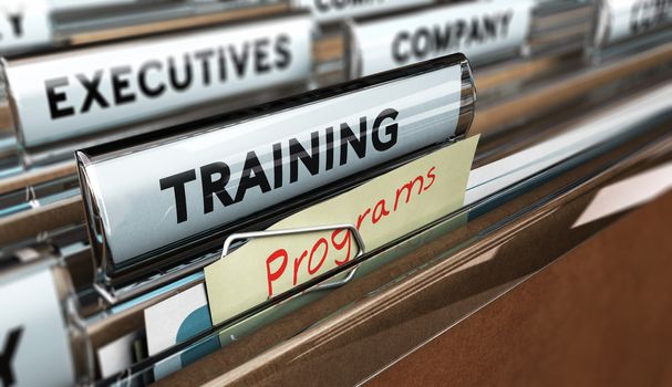 Close up on a file tab with the word training, focus on a yellow, note where it is hanwritten programm, blur effect. Concept image for illustration of employee, training