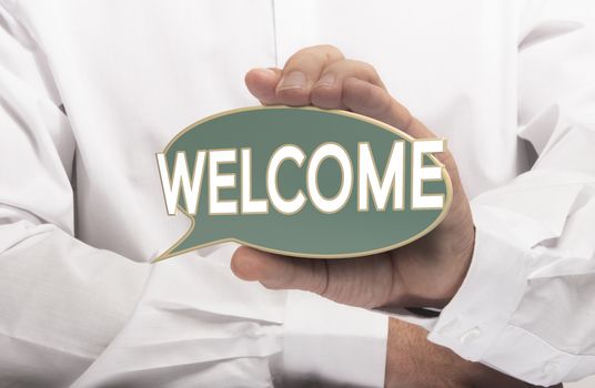 Businessman holding a welcome sign in left hand. Conceptual image