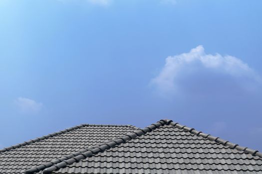 Roof house with tiled roof on blue sky