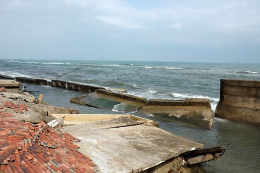 Erosion at seaside resort from climate change situation, wave broken building, very unsafe, danger, environment risk of worldwide when sea level rise by warming, scene at Cua Dai, Hoi An, Vietnam
