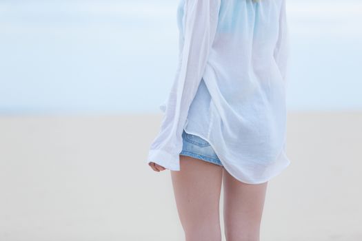 Beautiful sensual woman alone at beach. Melancholic vintage mood. Summer moved on.