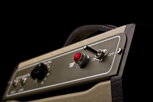 Close up of a small electric guitar amplifier on dark background 
