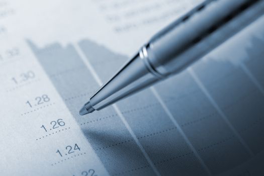 Horizontal top view of a pencil above a graphic printed on paper