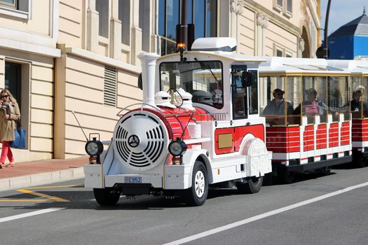 Monte-Carlo, Monaco - March 9, 2016: Red and White Trackless Train for Sightseeing in Monaco on the Street of Monte-Carlo, Monaco in the south of France