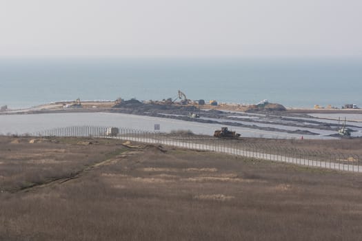Taman, Russia - March 8, 2016: A view of the Tuzla Spit and the construction of transport passage through the Kerch Strait from the Taman, which will connect the Kerch and Taman peninsula, as of March 2016