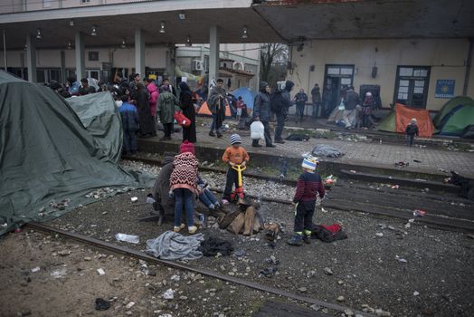 GREECE, Idomeni: Children play along the railway tracks next to tents at the Idomeni refugee camp on the Greek Macedonia border on March 15, 2016 in Idomeni, Greece. Yesterday, an attempt by some of the residents of the camp to cross the border to Macedonia was thwarted by Macedonian security forces who returned the migrants to Greece. The decision by Macedonia to close its border to migrants last week has left thousands of people stranded at the Greek transit camp. The closure, following the lead taken by neighbouring countries, has effectively sealed the so-called western Balkan route, the main migration route which has been used by hundreds of thousands of migrants to reach countries in western Europe, such as Germany. Humanitarian workers have described the conditions at the camp as desperate, which has been made much worse by recent spells of heavy rain.