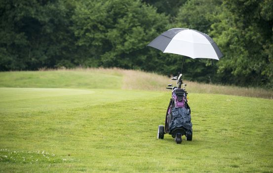 golcar with clubs on the green