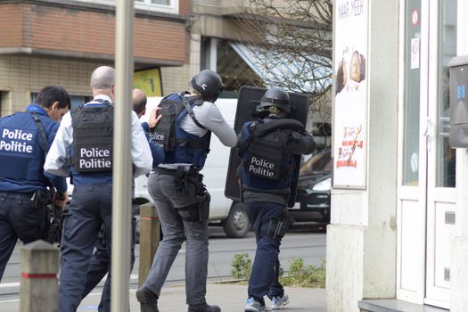 BELGIUM, Brussels: Police officers stand guard at the site of a shooting on Dries-Driesstraat at Forest-Vorst, in Brussels, on March 15, 2016. Shots were fired at Belgian police in the capital Brussels as they carried out an operation linked to the Paris attacks, Belgian prosecutors told. 