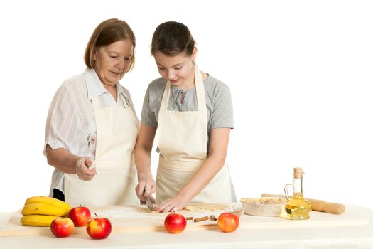 the grandmother and the granddaughter knife dough on a wooden board