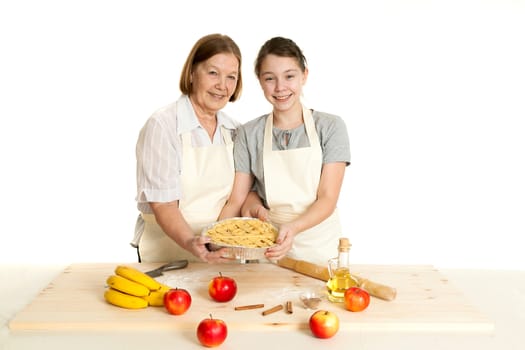 the grandmother and the granddaughter hold beautiful pie in hand