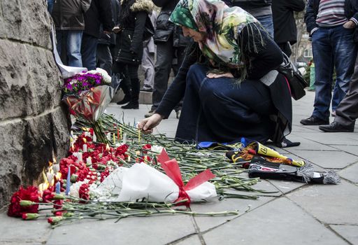 TURKEY, Ankara: A woman leaves carnations at a makeshift memorial for the victims of Sunday's suicide bomb attack in Ankara, on March 15, 2016 in Ankara, near the site of a suicide car bombing on March 13 that left 35 dead.Turkish warplanes pounded Kurdish rebel bases in northern Iraq on March 14, the day after a suicide car bomb tore through downtown Ankara killing at least 35 people, the third attack on the capital in five months. There was no immediate claim of responsibility for the latest carnage, which reduced cars and buses to charred hulks on a busy road in the heart of the city, wounding more than 120 people. 