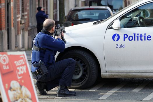 BELGIUM, Brussels: A police officer takes aim at the site of a shooting on Dries-Driesstraat at Forest-Vorst, in Brussels, on March 15, 2016. Shots were fired at Belgian police in the capital Brussels as they carried out an operation linked to the Paris attacks, Belgian prosecutors told.