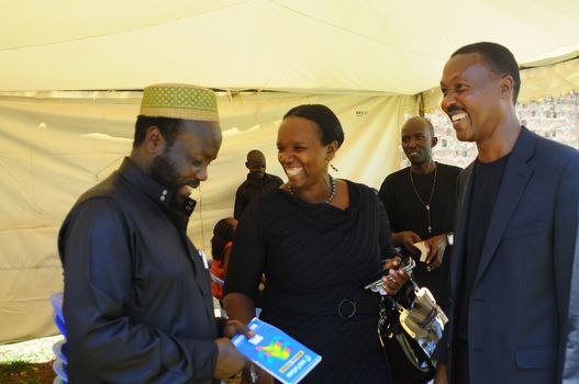 UGANDA, Kampala: President of Forum for Democratic Change (FDC), Mugisha Muntu (R) speaks with the Forum for Democratic Change (FDC) secretary for mobilisation Ingrid Turinawe (C) and FDC's Muhammad Katuramu (L), during the Free my vote campaign launch in Kampala, on March 15, 2016. The Free my vote campaign, that includes praying every Tuesday around the country, is organized by the FDC (Forum for Democratic Change) in protest of the outcome of the February 18 presidential election and the subsequent home detention of the party's presidential candidate Dr Kizza Besigye who has been under police siege since the declaration of presidential results.