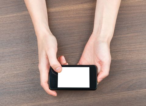 Female hands holding smartphone with blank screen on isolated white background