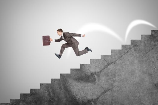 Businessman with suitcase running fast down stairs