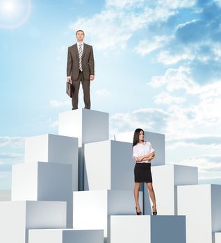 Business people on boxes pile on blue sky background