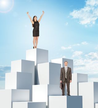 Businesspeople on boxes pile on blue sky background