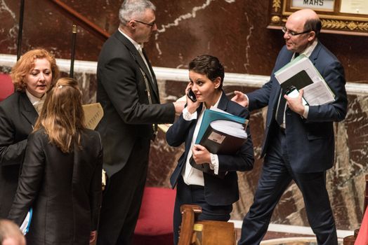 FRANCE, Paris : French Minister for Education Najat Vallaud-Belkacem uses a mobile phone during a session of questions to the government on March 15, 2016 at the National Assembly in Paris.