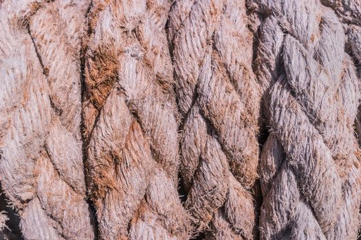 Close-up of an old frayed boat rope as a nautical background.