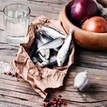 Glass of vodka,smoked sprat,spices in a rustic traditional Russian style