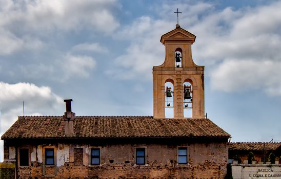 The basilica of Santi Cosma e Damiano is a church in the Roman Forum,parts of which incorporate original Roman buildings. Tower of belfry and cloudy sky.