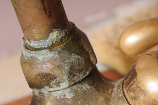 Hard water deposit on a tap with blurry background