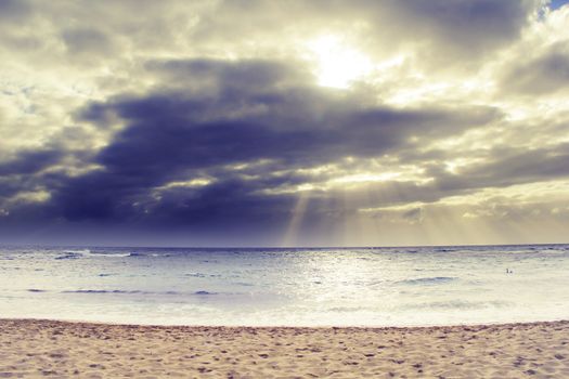 ray of sun over the beach at Kauai, Hawaii with cloudy sky