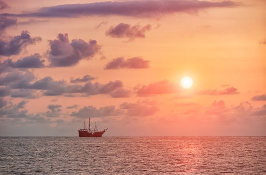 Sail ship in Puerto Vallarta, Mexico, with sunset in the background.