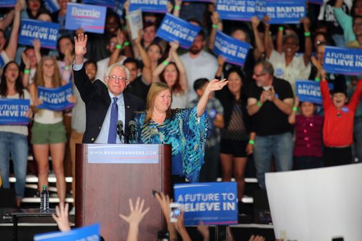 UNITED STATES, Phoenix: Democratic presidential candidate Sen. Bernie Sanders (L) and his wide Jane O'Meara Sanders (R) greet a crowd gathered at the Phoenix Convention Center during a campaign rally on March 15, 2016 in Phoenix, Arizona. Hillary Clinton won the Democratic primary elections in Florida, North Carolina and Ohio, while Missouri and Illinois remain tight races.