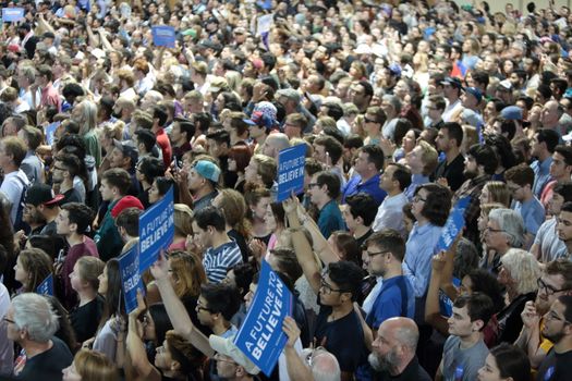 UNITED STATES, Phoenix: Members of the crowd show their support for Democratic presidential candidate Sen. Bernie Sanders at the Phoenix Convention Center during a campaign rally on March 15, 2016 in Phoenix, Arizona. Hillary Clinton won the Democratic primary elections in Florida, North Carolina and Ohio, while Missouri and Illinois remain tight races.