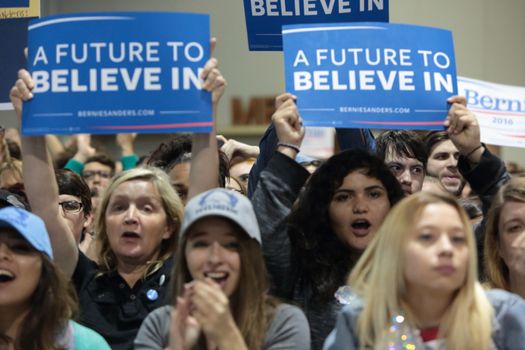UNITED STATES, Phoenix: Members of the crowd show their support for Democratic presidential candidate Sen. Bernie Sanders at the Phoenix Convention Center during a campaign rally on March 15, 2016 in Phoenix, Arizona. Hillary Clinton won the Democratic primary elections in Florida, North Carolina and Ohio, while Missouri and Illinois remain tight races.
