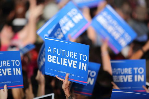 UNITED STATES, Phoenix: Members of the crowd show their support for Democratic presidential candidate Sen. Bernie Sanders at the Phoenix Convention Center during a campaign rally on March 15, 2016 in Phoenix, Arizona. Hillary Clinton won the Democratic primary elections in Florida, North Carolina and Ohio, while Missouri and Illinois remain tight races.