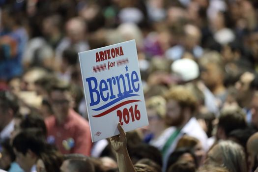 UNITED STATES, Phoenix: Members of the crowd show their support for Democratic presidential candidate Sen. Bernie Sanders at the Phoenix Convention Center during a campaign rally on March 15, 2016 in Phoenix, Arizona. Hillary Clinton won the Democratic primary elections in Florida, North Carolina and Ohio, while Missouri and Illinois remain tight races.