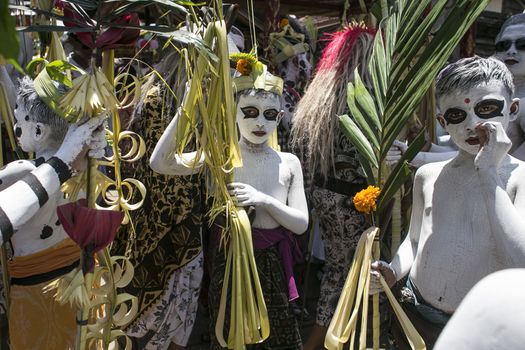 INDONESIA, Gianyar, Bali: Young members of the village community walk around the village with their bodies painted during the Grebeg ritual, on March 16, 2016, in Tegallalang village, Gianyar, Bali, Indonesia. During the biannual ritual, young members of 