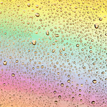 Water drops on a background of iridescent glass.