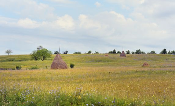 Countryside landscape with haystack in summer time