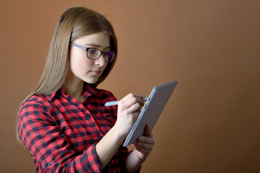 Teenage girl with tablet at home, learning.