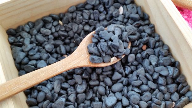 wooden spoon full with black gravel for plant decorating