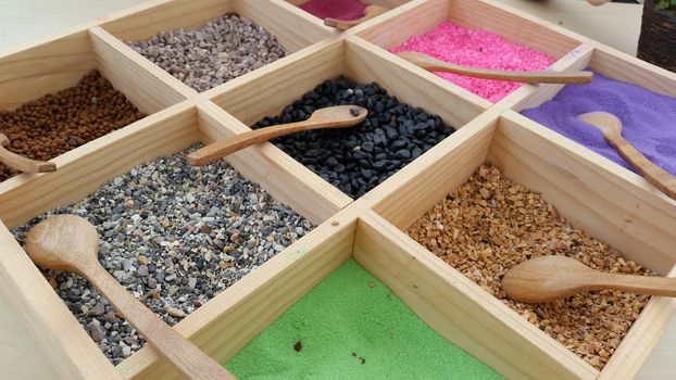 Various and colorful gravel, pebble and sand for plant decoration basket