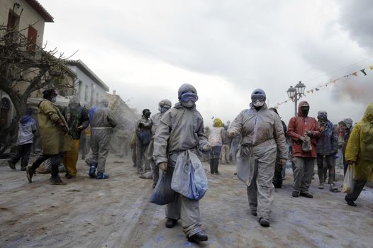 GREECE, Galaxidi: People walk through Galaxidi holding bags of flour on March 14, 2016. The battle takes place every year on 'Clean Monday', which marks the beginning of the Christian lent festival.The coastal town has observed this festive event which dates back to the mid 19th century. 