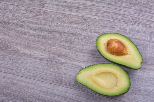 Cut avocado on a wooden background