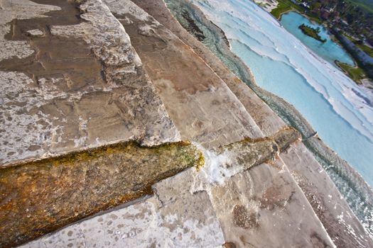 Culvert cut in stone feeding hot spring water into pools at Permukkale