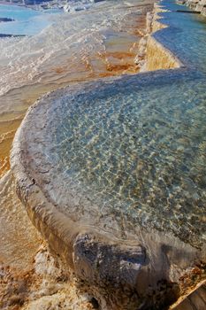 Travertine pool with hot water from spring at Pamukkale in Turkey