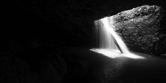 Natural Bridge Waterfall in Springbrook on the Gold Coast hinterlands, Queensland. Black and White image