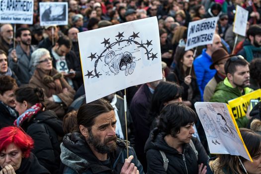 SPAIN, Madrid: Demonstrators hold placards as they protest against the European Union - Turkey migrant deal proposal to deport refugees back to Turkey, at Puerta del Sol square in Madrid on March 16, 2016.