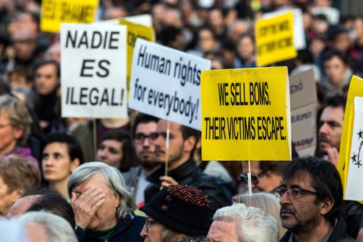 SPAIN, Madrid: Demonstrators hold placards as they protest against the European Union - Turkey migrant deal proposal to deport refugees back to Turkey, at Puerta del Sol square in Madrid on March 16, 2016.