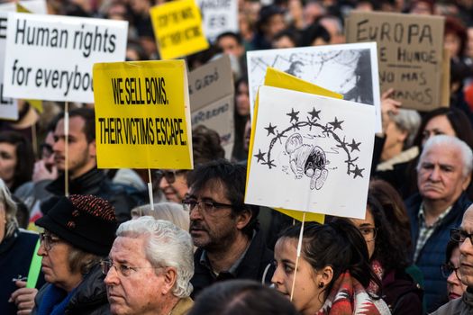 SPAIN, Madrid: Demonstrators hold placards as they protest against the European Union - Turkey migrant deal proposal to deport refugees back to Turkey, at Puerta del Sol square in Madrid on March 16, 2016.