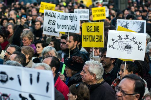 SPAIN, Madrid: Demonstrators hold placards as they protest against the European Union - Turkey migrant deal proposal to deport refugees back to Turkey, at Puerta del Sol square in Madrid on March 16, 2016.