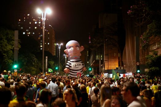 BRAZIL, Sao Paulo: A giant puppet representing former President Lula dressed-up as a prisoner is seen as thousands gather on the Paulista Avenue, in Sao Paulo, during a pro-impeachment rally, on March 16, 2016. Outraged Brazilians protested in Brasilia and Sao Paulo following the release of a taped phone call between President Dilma Rousseff and her predecessor Luiz Inacio Lula da Silva. On Sunday, an estimated three million Brazilians flooded the streets in nationwide protests calling for Rousseff's departure.